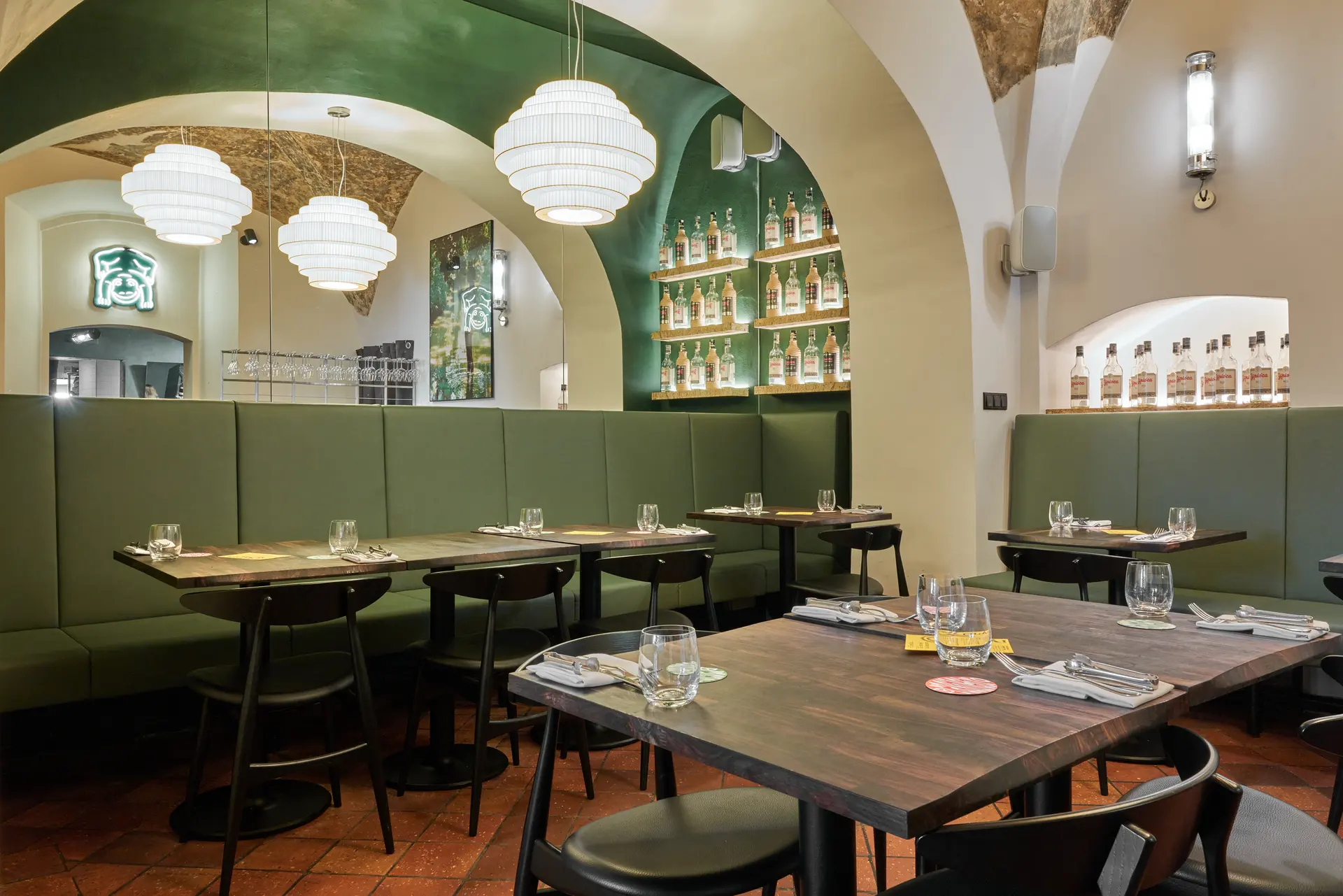 Interior of Brasileiro U Zelené žáby restaurant with dining area and bar.